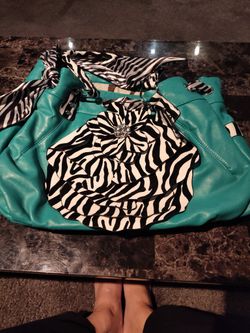 Large Teal Purse With Black And White Decor On It