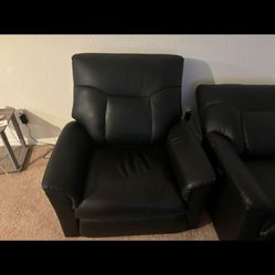 Two black leather recliners electric.