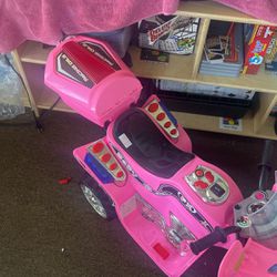 A Toddler, Pink Motorcycle, And A Black Toddler Piano