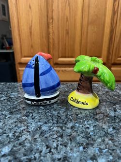 Vintage  Souvenir California Ceramic Sail Boat and Palm Tree Pair of Salt and Pepper Shakers.  Size approximately 4 inches tall.  Preowned has been on