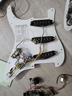 4 strat pickguards with some pickups