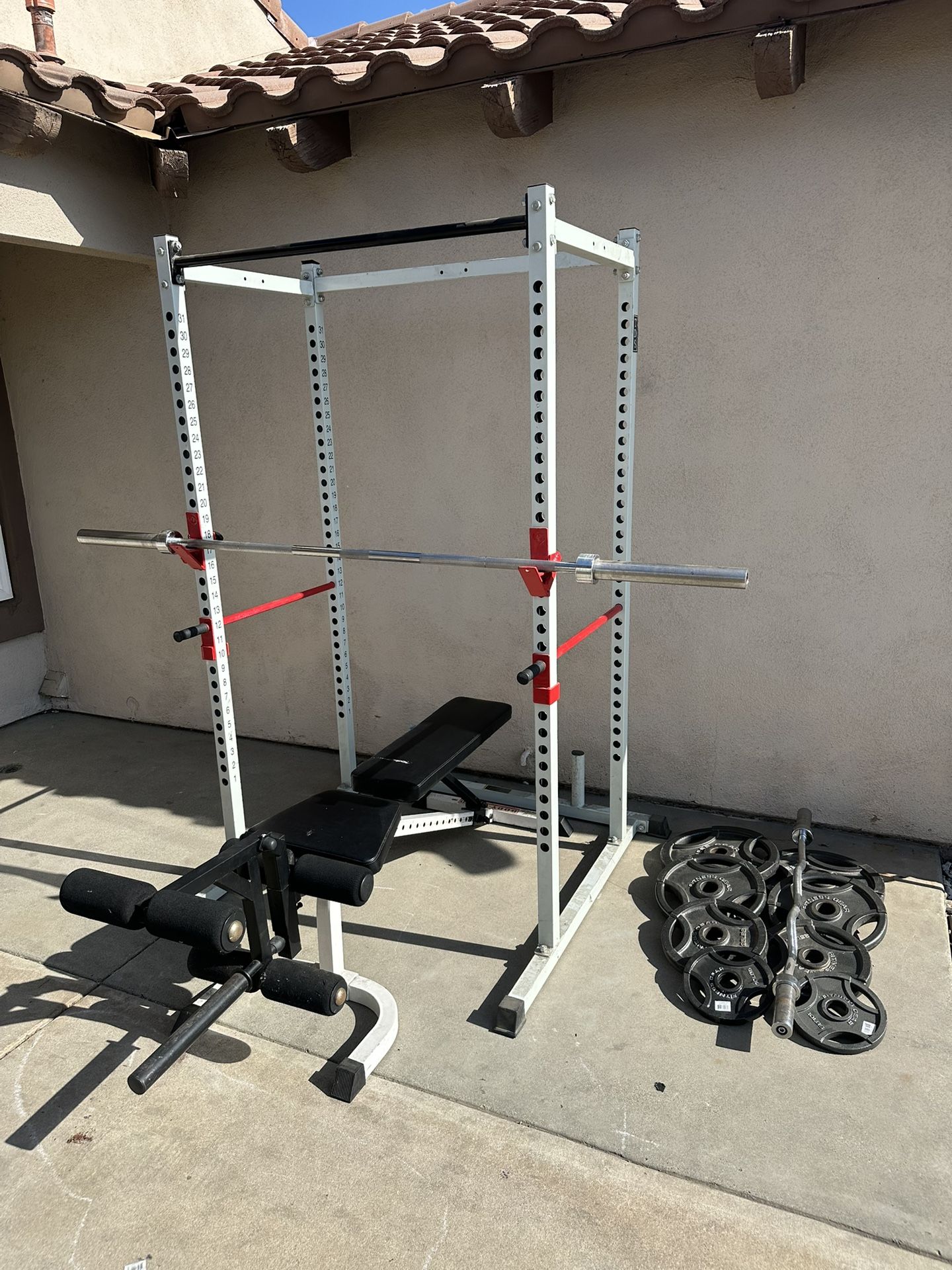 Bench press/squat rack with 7ft 45lbs bar plus 230lbs of Olympic weights and curl bar