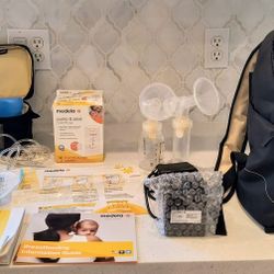 Medela Pump In Style Advanced Breast Pump Back Pack Backpack(with pump, accessories, cooler, ice pack, 2 bottles), milk storage bags & sterilize bag.
