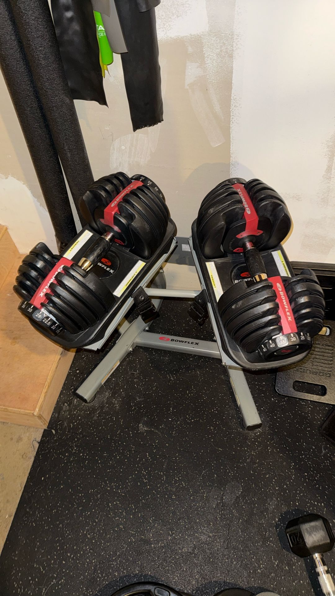 Bowflex 52.5 lb adjustable dumbbells and stand.