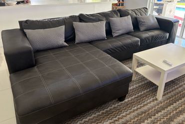 Used faux leather sectional -black with pillows