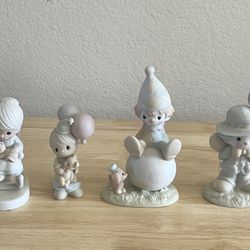 These items are vintage porcelain figurines from the Precious Moments collection.