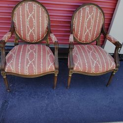 Elegant vintage armchairs with patterned upholstery.