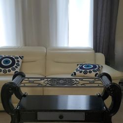 Ornate Glass-top coffe Table featuring a scroll-carved dark wood frame