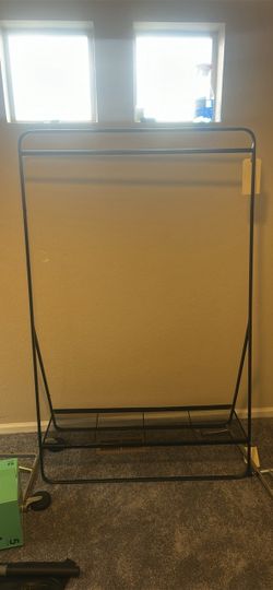 clothing rack with a lower shoe/storage shelf