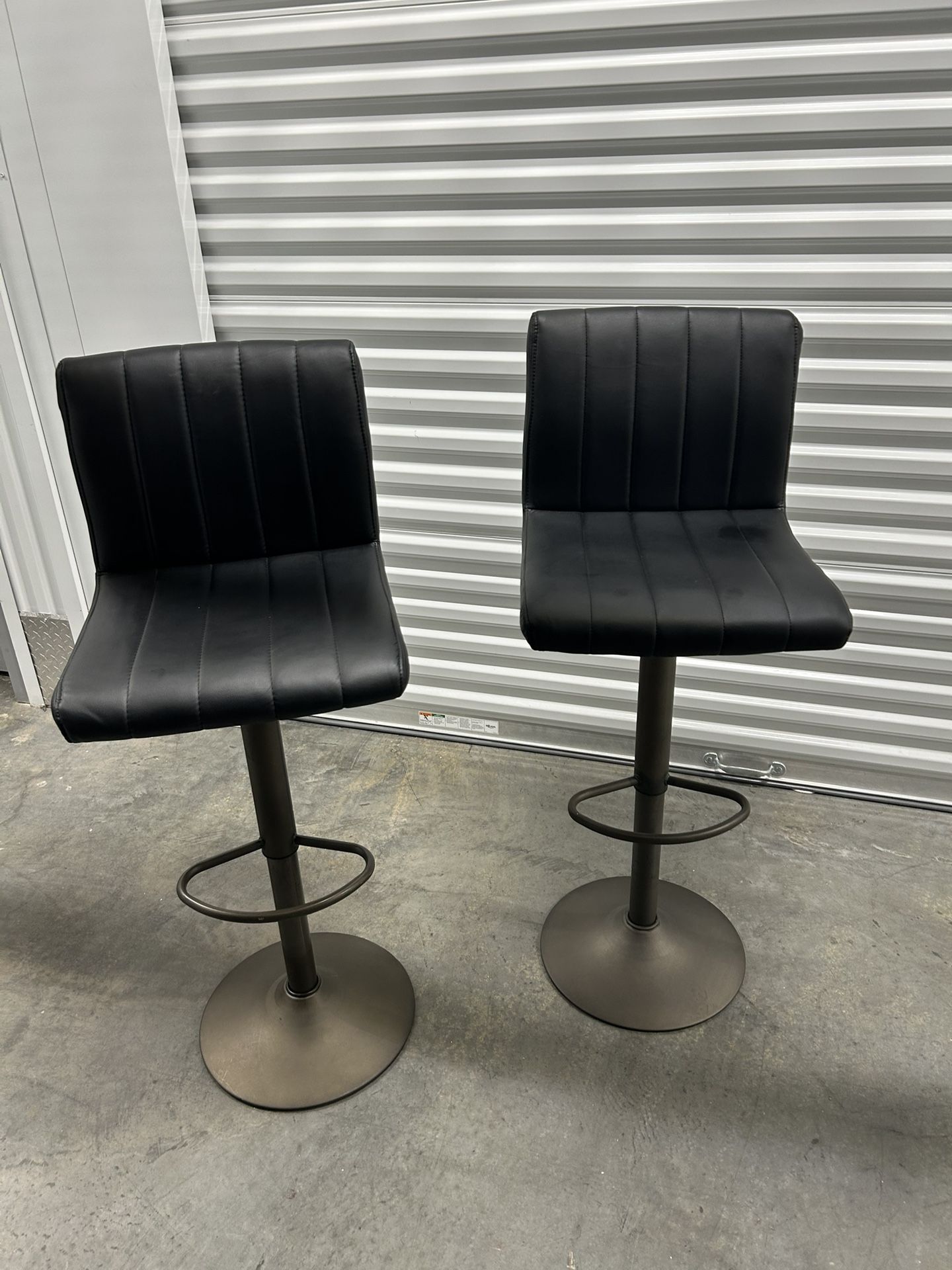 Two 30-46 in. H Adjustable Black Faux Leather Swivel Bar Stool