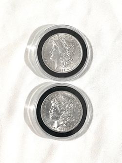 About uncirculated sealed in the capsules 1889 and 1890 Morgan silver dollars. Value at $108 each.