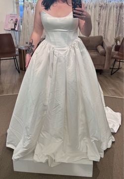 STRAPLESS BALLGOWN WEDDING DRESS WITH SATIN PLEATS AND CAT-EYE NECKLINE