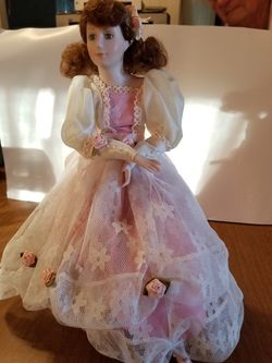 Vintage doll on stand.