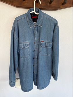 Wolverine casual denim button-up shirt jacket. Contrasting plaid fleece inner lining.