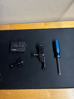 goPro hero nine black with carrying case and a couple attachments