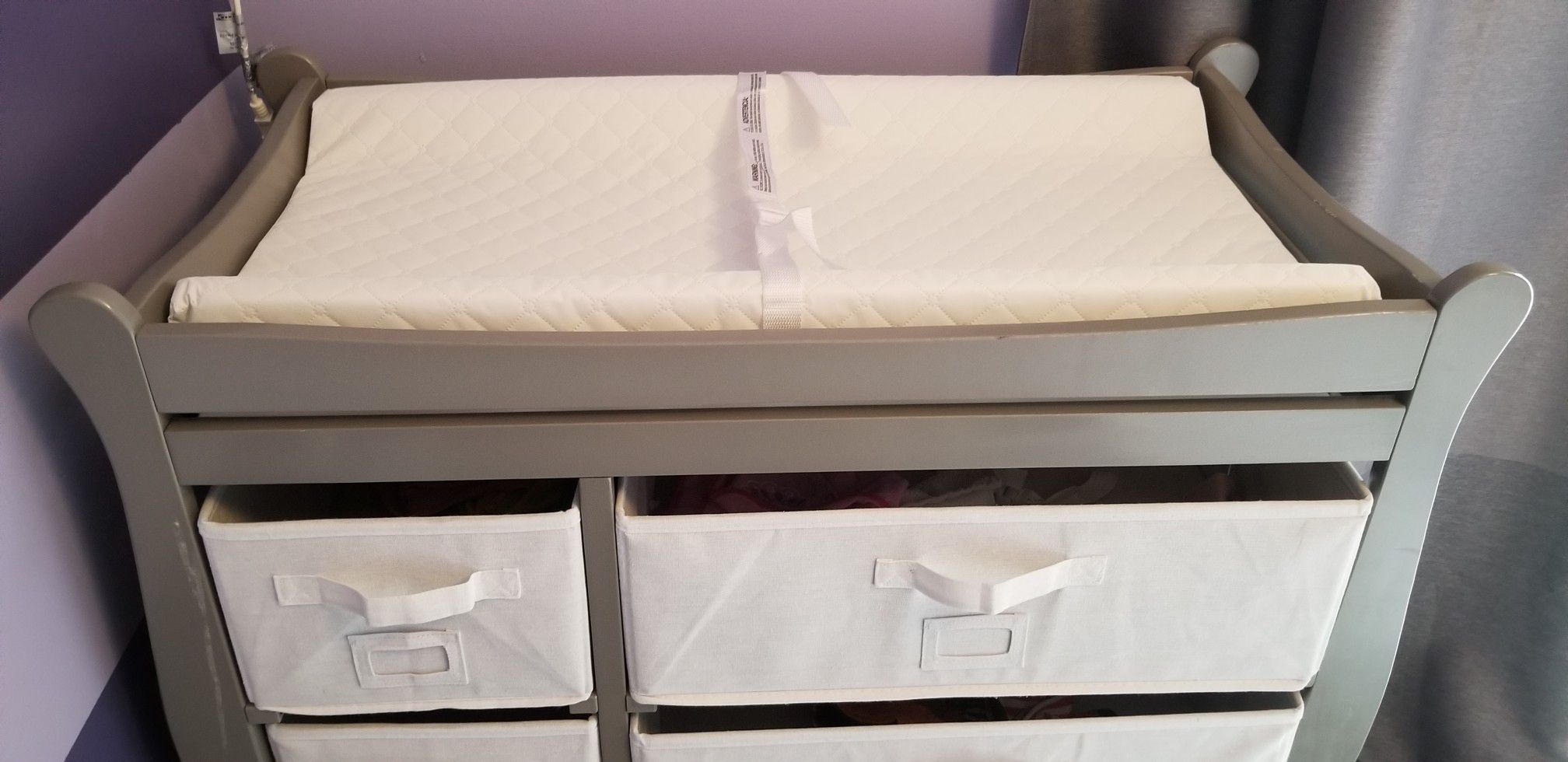 Baby changing table with canvas drawer storage.