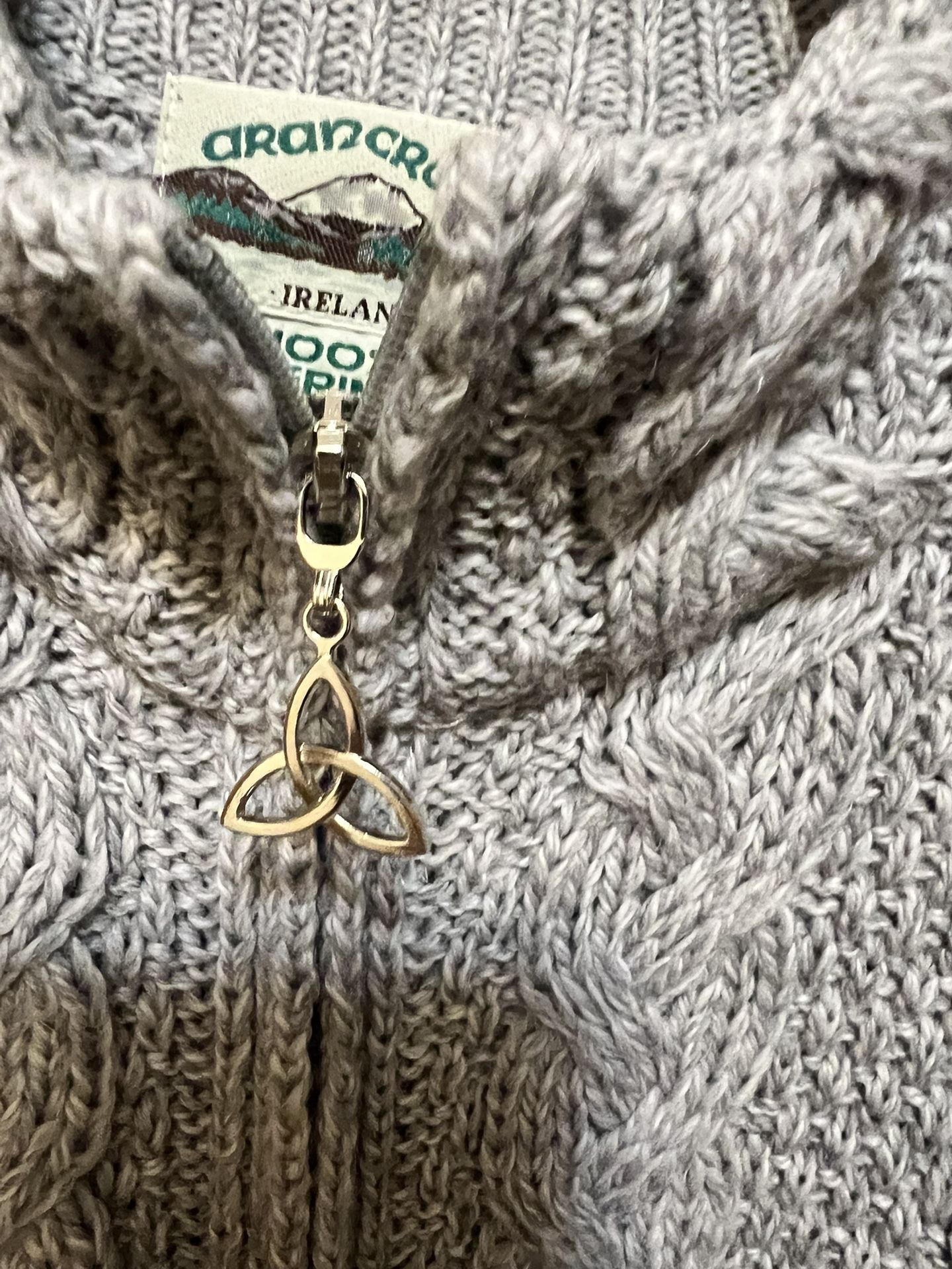 Aran Crafts 100% Merino Wool cable-knit cardigan with a Celtic knot zipper pull