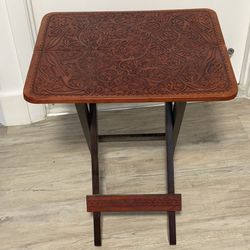 Ornate embossed leather-topped folding wooden snack table
