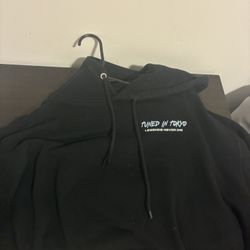 Selling a Tuned in Tokyo “Legends Never Die” black pullover hoodie with striking tiger + Japanese kanji graphic on the back. Condition is gently worn,