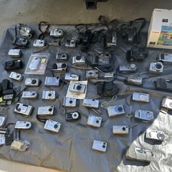 Lot of assorted cameras and camcorders - Sony, Canon, Fujifilm, Kodak, HP, Minolta, Polaroid, Nikon, Olympus, Casio