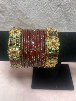 ornate red and gold Indian bridal chura set features Kundan work