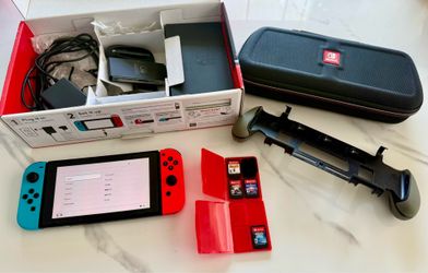 Nintendo Switch + 4 Games + 128GB microSD Card + Travel Case + Console Grip