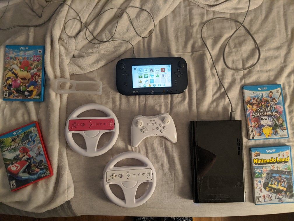 Wii U with 3 controllers, 2 wheels, and 4 games