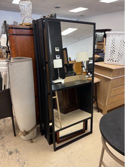 black metal frame styling station with an integrated full-length mirror