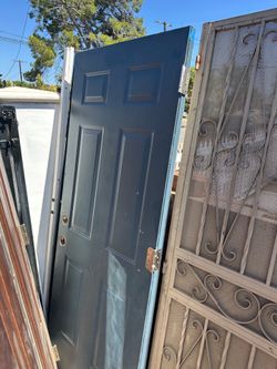 Durable steel or fiberglass exterior door has a classic 6-panel design. This slate blue door includes two pre-drilled holes for a handle and deadbolt.