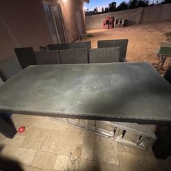 Wicker  Glass Table 7 Foot X 3.5 Foot With 8 Chairs Umbrella