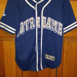 SMALL/MEDIUM 19 1/2 INCHES PIT TO PIT NOTRE DAME COLOSSEUM JERSEY WITH SEWN ON LETTERS AND LOGO