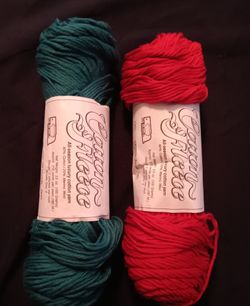 Two skeins wool blend yarn Red & green