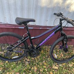 Mongoose Excursion mountain bike, 24-inch wheel, 21 speeds, girls frame, black / purple