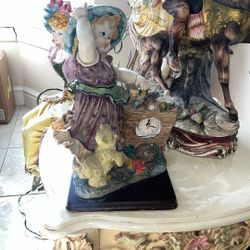 antique doll figurine with clock 