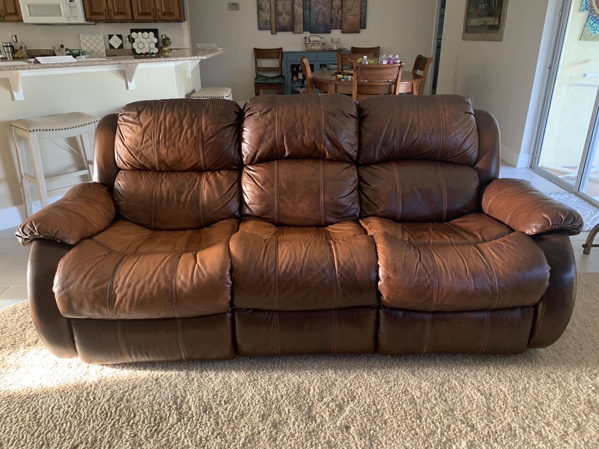 Leather reclining sofa and loveseat glider