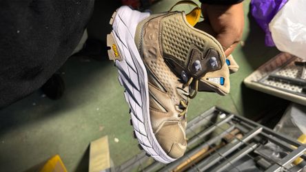 These are Hoka Anacapa Mid GTX hiking boots, recognizable by their distinctive Vibram outsole and Gore-Tex waterproofing.