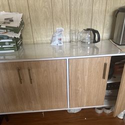 This stylish two-tiered storage cabinet/table offers ample storage space and is very modern and fashionable. It features four doors.