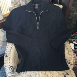 A black quarter-zip sweater by F/X Fusion