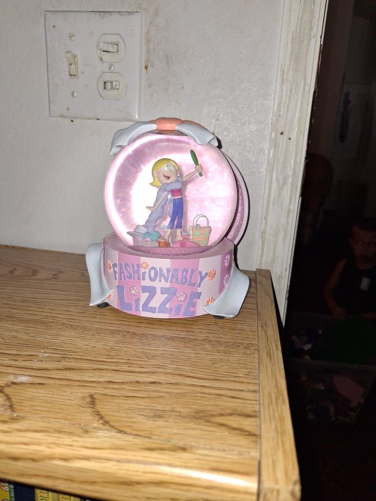 Fashionably, Lizzie, snow globe.
