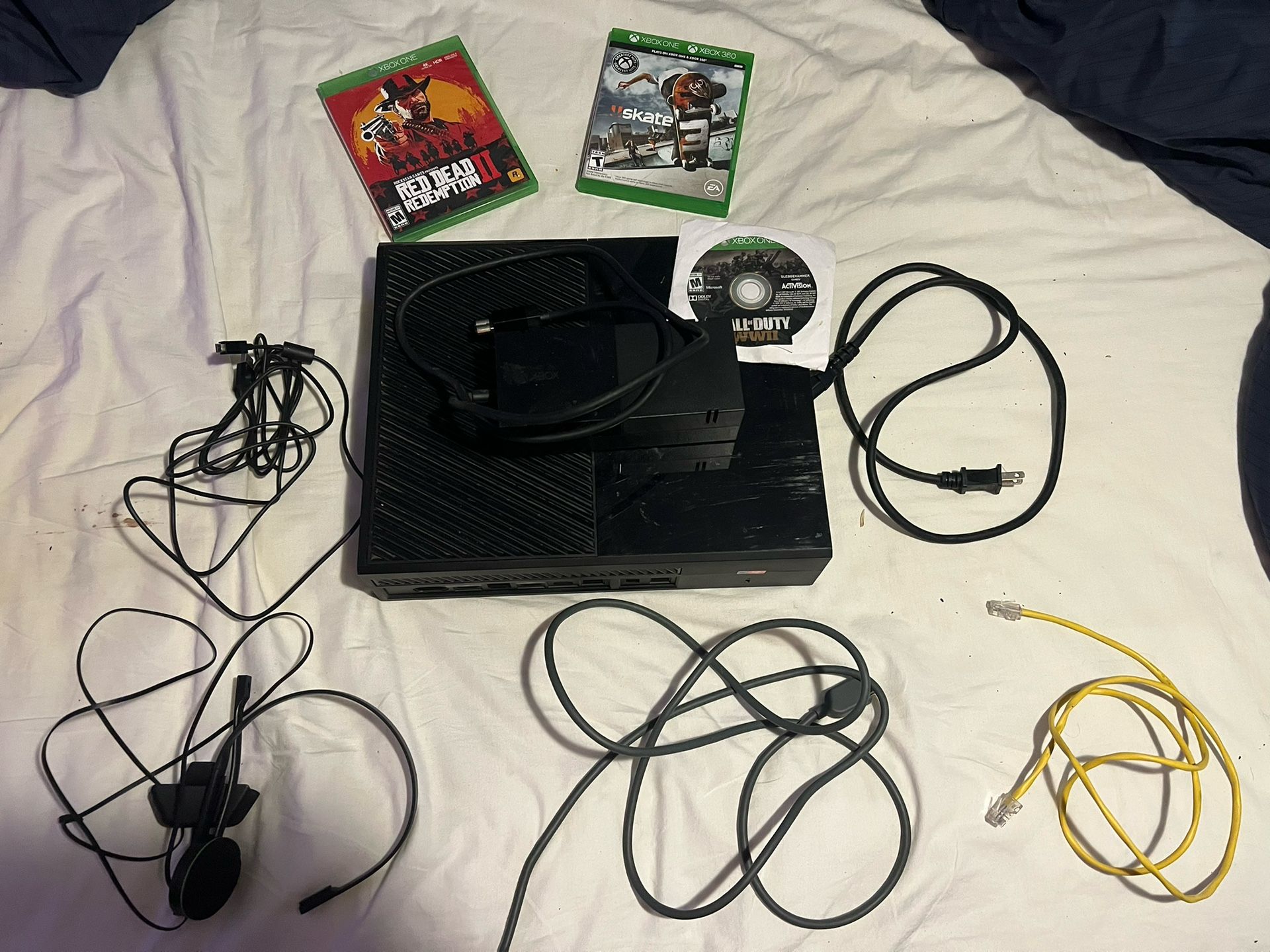 Original Xbox One w/ all necessary chords, two controllers + headset , ethernet cable, & misc games