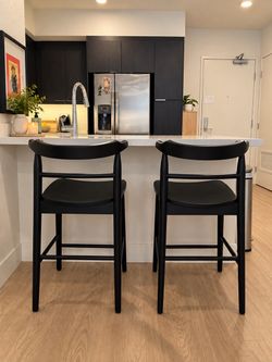 Black wooden kitchen counter stools
