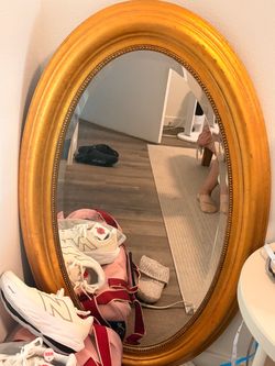 Gold oval mirror