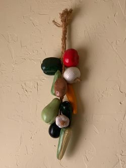 Vintage glazed ceramic vegetable and fruit wall hanging garland featuring a braided jute rope