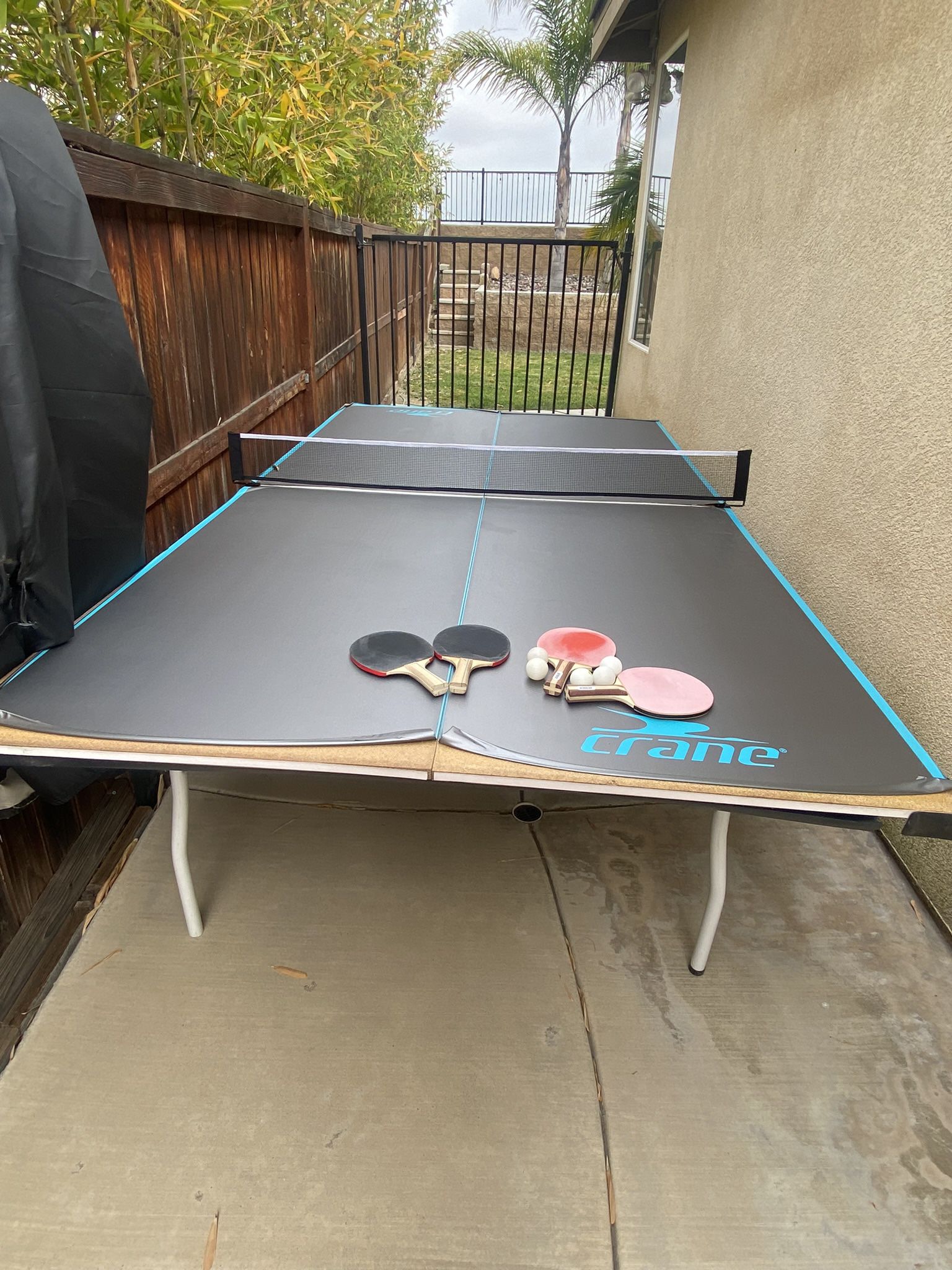 wood table tennis with rackets, balls and cover