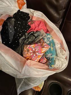 Three bags of women's clothing most are 13 to 14 size and some are petite. Extra large. Some are new attached dresses pants shirts sweaters are in new