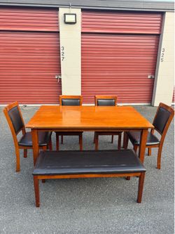 Wooden table and four chairs and a bench