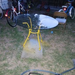 Round Glass-Too Dining Table With A Curved  Yellow-Painted Metal Frame 