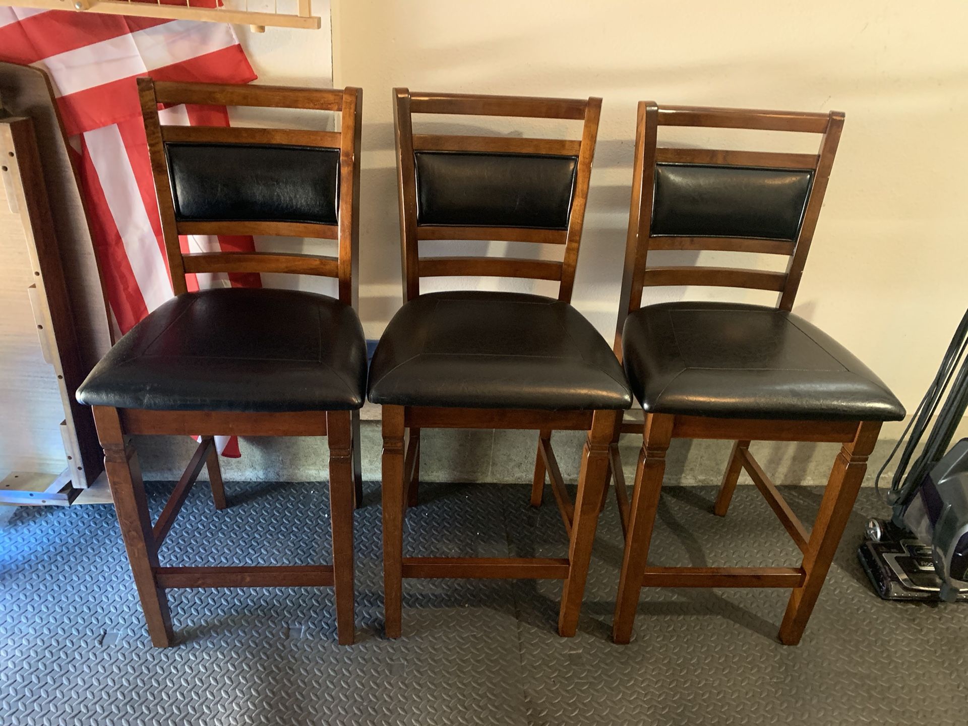 Three wood and leather bar stools! Small Place of damage just from the move. Otherwise is wonderful condition and high quality.