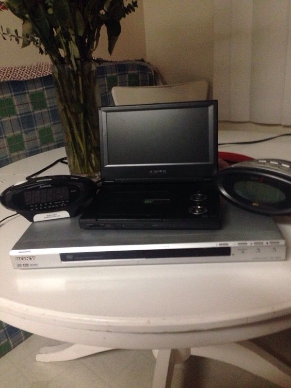 DVD, Portable DVD player, and two clocks with alarm and aux cord