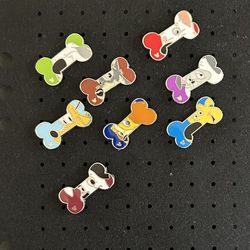 This is a collection of Disney "Hidden Mickey" Dog Bone pins from 2017. The pins feature different Disney dog characters